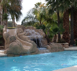Custom Chandler pool with integrated rock waterfall and water slide feature