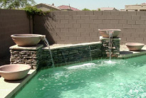 Luxury pool remodel in Chandler with a custom rock waterfall