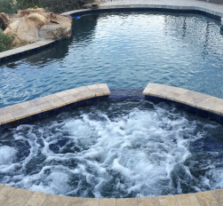 Custom-built outdoor spa connected to backyard pool in Chandler