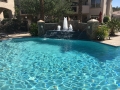 Detailed view of a Cantera stone pool water feature by True Blue Pools
