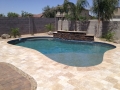 Pool water feature alongside baja steps and beach entry — True Blue Pools