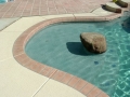 Pool remodel featuring baja steps and beach entry — True Blue Pools