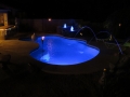 Custom pool lighting glowing after dark — pool by True Blue Pools (1)