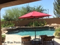 Rock waterfall pool with cascading water feature — True Blue Pools custom build