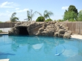 Rock waterfall, waterslide and grotto cave pool by True Blue Pools