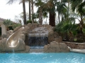 Custom Gilbert pool with waterslide and rock waterfall by True Blue Pools