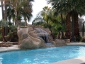 Custom waterslide and rock waterfall pool remodel in Gilbert by True Blue Pools