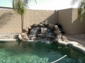 Big rock wall waterfall on a Mesa custom pool remodel by True Blue Pools