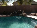 Rock wall waterfall on a Mesa custom pool remodel by True Blue Pools