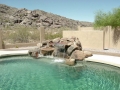 Mesa pool waterfall remodel — custom rock water feature by True Blue Pools