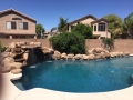 Two natural rock waterfalls with rock coping — custom pool by True Blue Pools