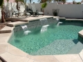 Mesa custom pool remodel with waterfall, entry steps and sheer descent feature by True Blue Pools