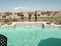 Chandler custom pool remodel with waterfall and sheer descent water feature by True Blue Pools