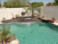 Custom Mesa pool waterfall remodel with sheer descent water feature by True Blue Pools