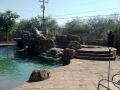 Pool spa with adobe-stone rock feature — True Blue Pools (9)