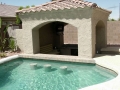 Custom Tempe pool with built-in swim-up bar table and stools by True Blue Pools